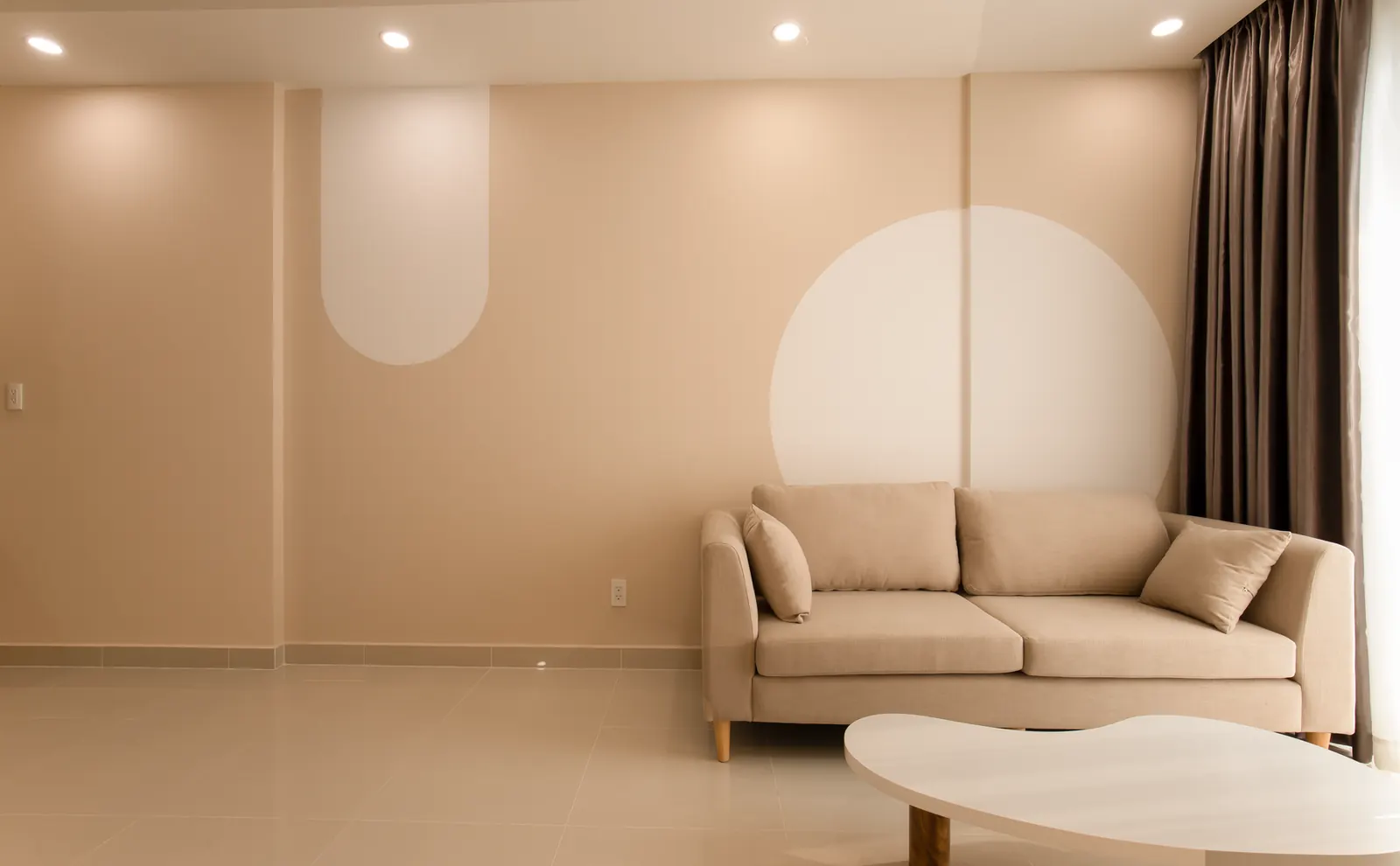 Sala bege tranquila com sofá e luz indireta